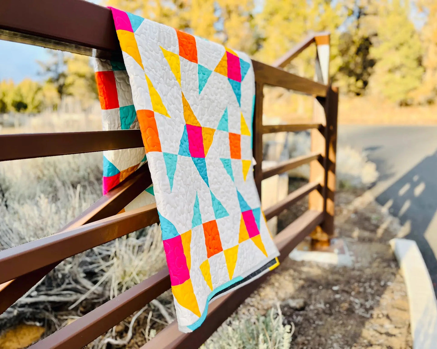 Beautiful quilt on a gate outside at the park.