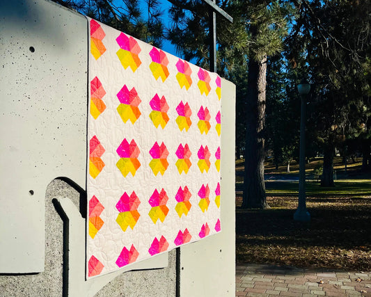 Colorful quilt with geometric pattern on a wall outdoors